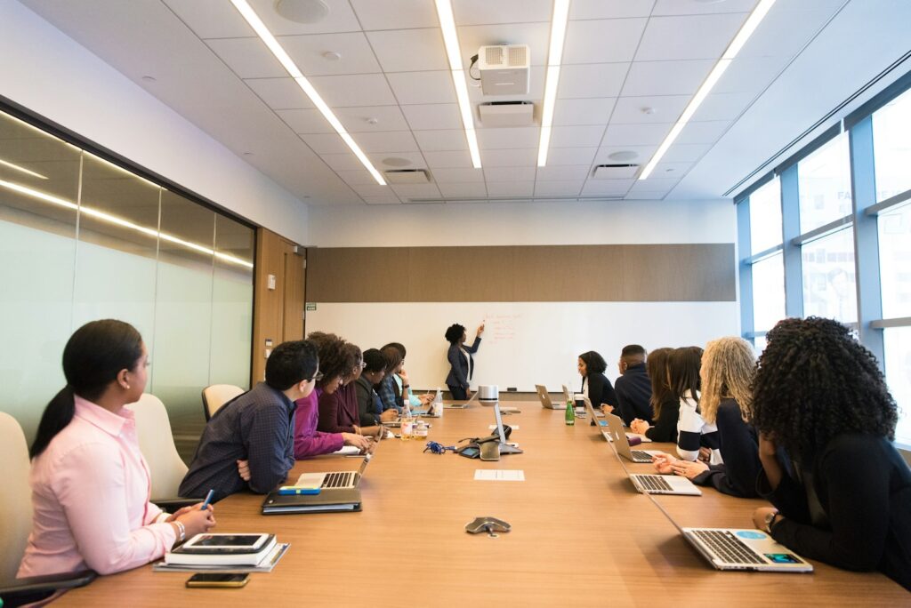 Team sitzt am Konferenztisch und bespricht im Entscheidungsmeeting die Bewertung von Kandidaten